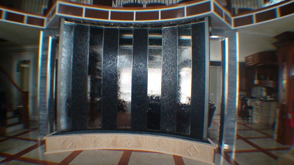 curved indoor water wall lobby entrance glass stone waterfall fountain