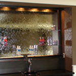 glass waterfall bar with drink shelves