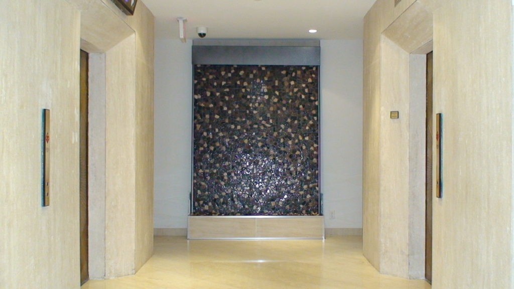 patterned stone indoor floor standing waterfall stainless metal trim