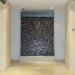 patterned stone indoor floor standing waterfall stainless metal trim